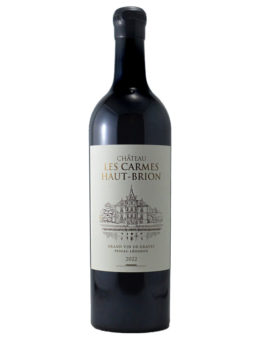 Bordeaux-type red wine bottle labeled 'Chateau Les Carmes Haut-Brion' on a white background. Etched drawing of a chateau. Text Grand Vin De Graves and Pessac-Leognan' appears above a 2022 vintage marque. Enclosure is black wax.