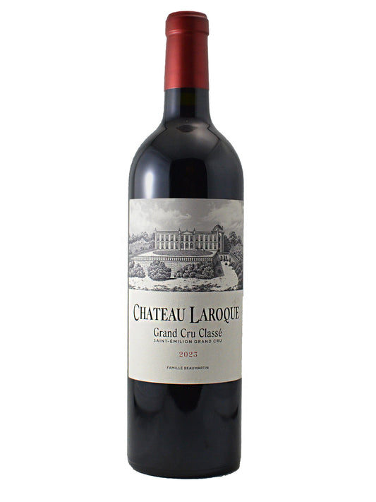 A bottle of Chateau Laroque Grand Cru Classique red wine from 2023, featuring a dark glass bottle with a red foil seal and a cream-colored label depicting a chateau illustration.