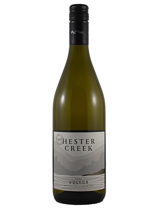 White wine bottle labeled 'Hester Creek' on a white background with a stylised body of water/distant mountains. Black screw cap enclosure.