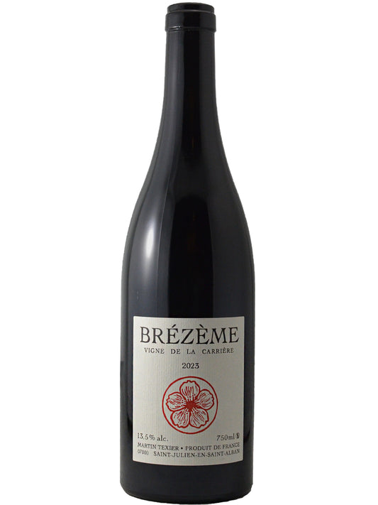 A bottle of Brézème red wine by Martin Tixer, featuring a dark glass bottle with a white label and a red floral design, set against a plain white background.