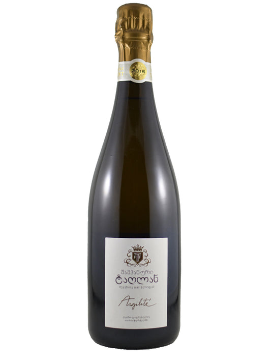 A bottle of Tarlant Argilité Brut Champagne with a white label and gold foil, set against a plain white background.