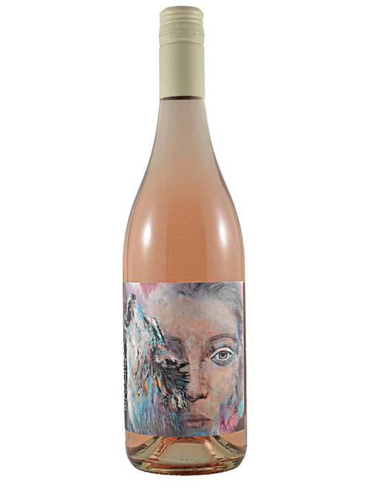 Wine bottle with a colorful label featuring a painterly image of a howling wolf over a woman's face. Cream coloured screwcap enclosure. All set against a plain white background.