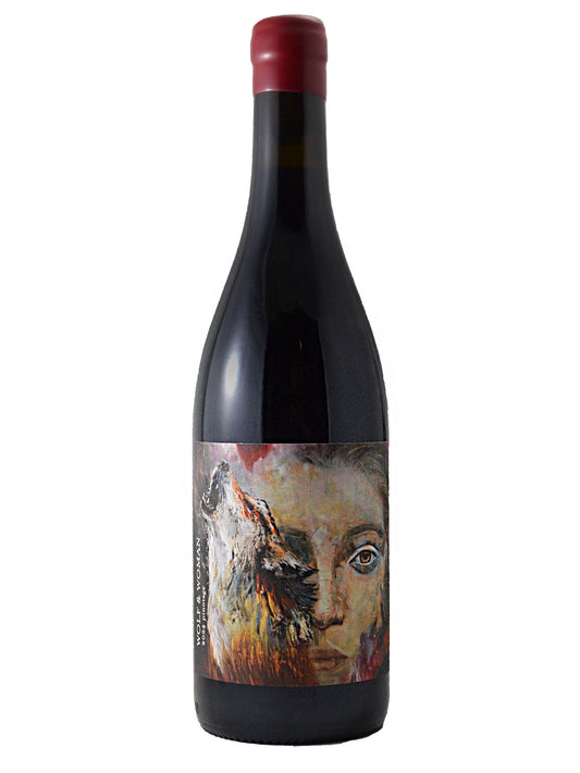 Wine bottle with red wax enclosure & an artistic label with a painterly image of a howling wolf over a woman's face, all set against a white background.